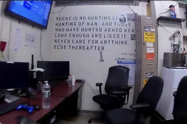 A photo of a Brooklyn precinct's wall containing the Hemingway quote: “There is no hunting like the hunting of man, and those who have hunted armed men long enough and liked it, never care for anything else thereafter.” :